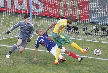 South Africa's Katlego Mphela (R) scores a goal past France's Gael Clichy (centre) and goalkeeper Hugo Lloris