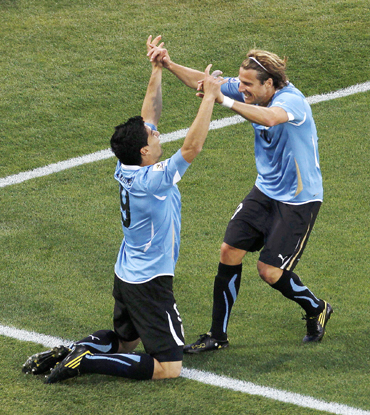 Uruguay's Luis Suarez celebrates with team mate Diego Forlan after scoring against Mexico