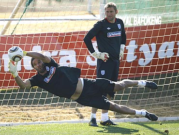 England keeper Robert Green (right) watches fellow goalkeeper David James make a save during a training session