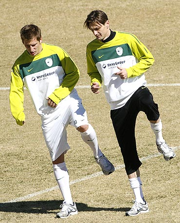 Slovenia's Valter Birsa (left) and Milivoje Novakovic go through the paces at a training session