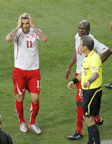 Switzerland's Behrami reacts after receiving a red card