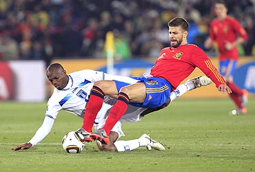 Spain's Gerard Pique (right) and with Honduras' David Suazo vie for possession
