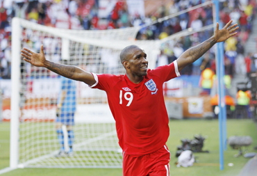 England's Jermain Defoe celebrates after scoring the first goal past Slovenia's goalkeeper Samir Handanovic