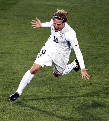 Uruguay's Diego Forlan celebrates his goal against South Africa