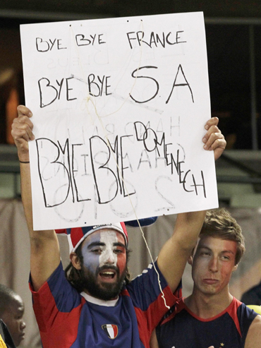 A fan carries a placard bidding farewell to the French and South African teams