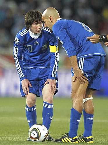 Lionel Messi (left) chats with Juan Sebastian Veron during the match
