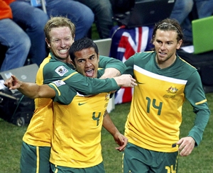 Tim Cahill (centre) celebrates after putting Australia ahead