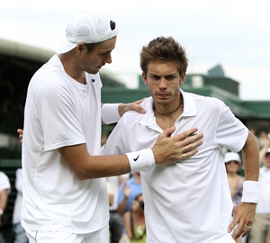 Isner embraces Mahut at the end of the match