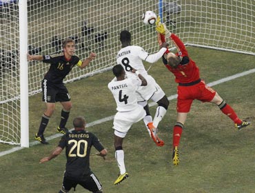 Germany's goalkeeper Neuer makes a save next to Ghana's Mensah