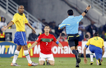 Brazil's Maicon (L) and Portugal's Cristiano Ronaldo (C) react to referee Benito Archindia of Mexico
