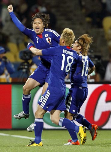 Keisuke Honda (left) celebrates his goal with team mates