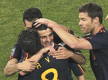 Spain's David Villa (centre) celebrates with teammates after scoring against Chile