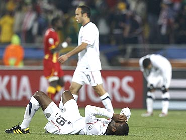 United States' Edu and Langdon Donavan react after their loss to Ghana