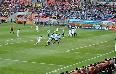 A South Korean player takes a free-kick