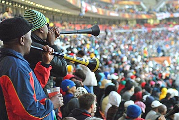 Fans cheer their teams by blowing the vuvuzelas
