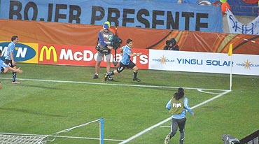 Suarez runs towards the corner flag to celebrate
