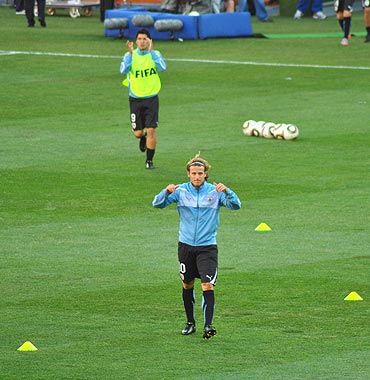 Diego Forlan warms up before the match