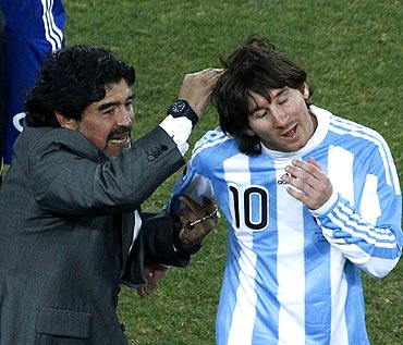Argentina coach Diego Maradona celebrates with Lionel Messi