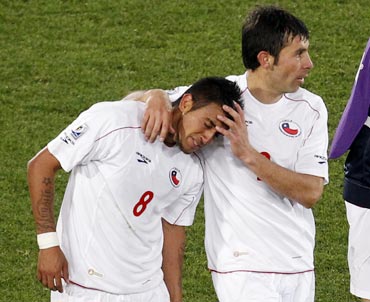 Chile's Ismael Fuentes consoles Arturo Vidal (left) at the end of the match