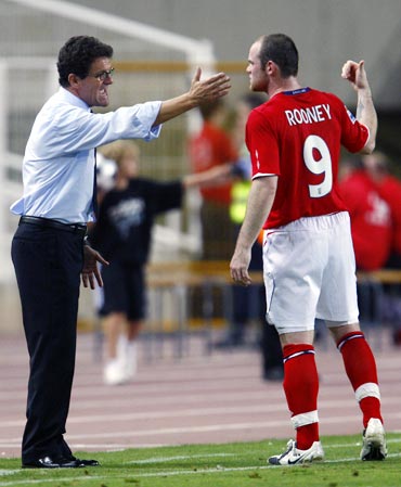 Wayne Rooney speaks to England manager Fabio Capello
