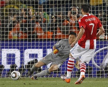 Paraguay's Cardozo scores the winning penalty against Japan's Eiji Kawashima during a penalty shootout