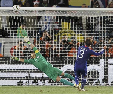 Japan's Komano hits the crossbar during a penalty shootout against Paraguay