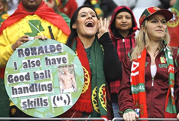 A fan displays a naughty placard directed towards Ronaldo