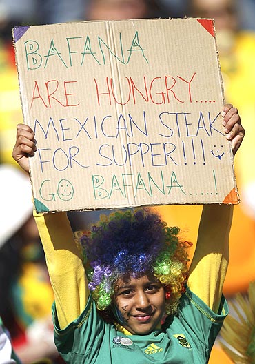 A South African fan holds an interesting placard