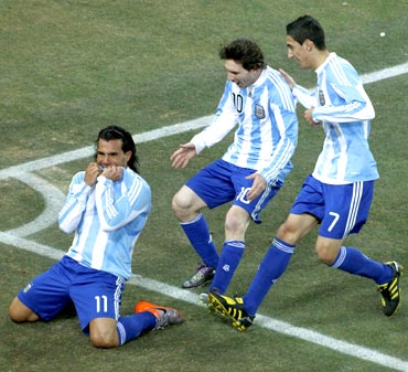 Carlos Tevez celebrates scoring a goal with team mates