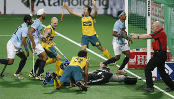 Australia's Hammond and Schubert celebrate after Abbott scored the third goal during their match against India