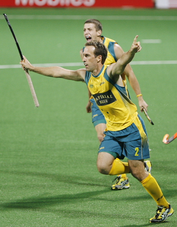Australia's Liam De Young celebrates with his team mate Orchard after scoring the first goal during their match against India