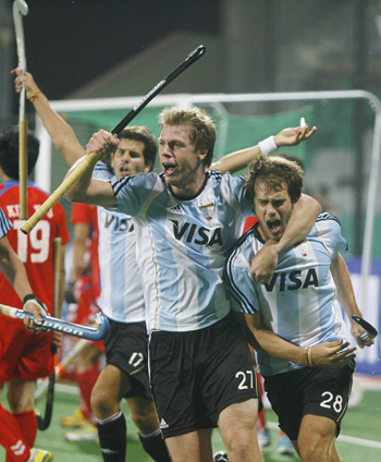 Argentina's Lopez, Rossi and Callioni celebrate the team's first goal during their match against South Korea