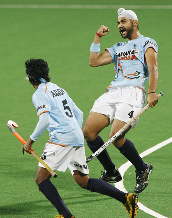 India's Sandeep Singh celebrates with his team mate Halappa after scoring the team's first goal during their match against Spain