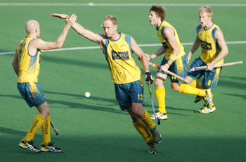 Luke Doerner celebrates with his teammates Hammond, Ockenden, and Butturini during their match against Spain