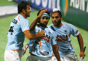Shivendra Singh (centre) celebrates with his team mates after scoring against South Africa
