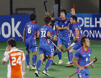 South Korea's Nam celebrates with his teammates after scoring the first goal during their match against the Netherlands