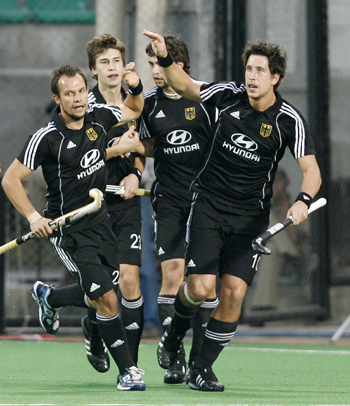 Germany's Jan-Marco Montag (right) celebrates scoring a goal against England with team mates during their semi-final match in the men's Hockey World Cup in New Delhi
