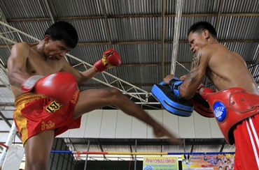 Blind boxer Salee practises with his trainer at a boxing camp