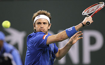 Mardy Fish of the US plays a return during his first round match against Michael Berrer of Germany