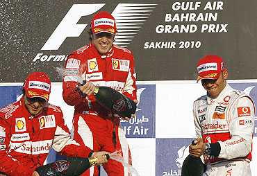 Ferrari's Felipe Massa (left) and Fernando Alonso (centre) celebrate their podium finish with McLaren's Lewis Hamilton