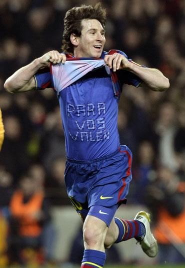 Messi celebrates after scoring a hat-trick against Valencia