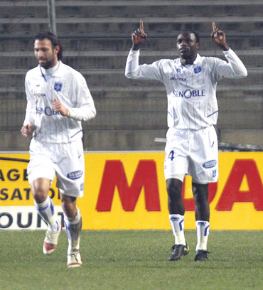Auxerre's Oliech celebrates with team-mates after scoring against Montpellier