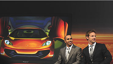 Lewis Hamilton (left) and Jenson Button speak during the car launch