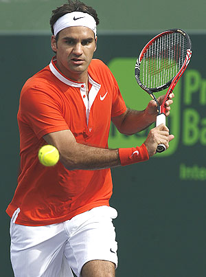 Roger Federer plays a return 