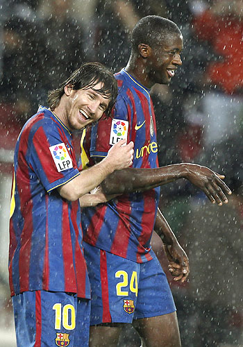 Barcelona's Lionel Messi (left) celebrates with team-mate Yaya Toure after scoring against Tenerife