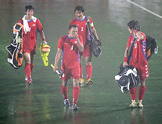 South Korean players walk off the turf after their final match against India in the Sultan Azlan Shah Cup hockey tournament was suspended in Ipoh, Malaysia on Sunday