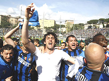 Inter Milan's Diego Milito celebrates with team-mates after winning the Serie A title on Sunday