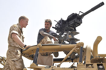 David Beckham (right) is shown a Grenade Machine Gun during a visit to Camp Bastion in Afghanistan