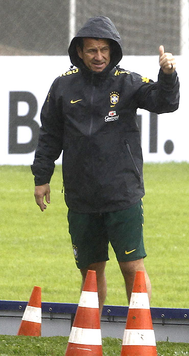 Brazil's head coach Dunga gestures to his players during a training session in Curitiba