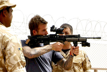 Beckham is shown some of the weapons used by front line troops